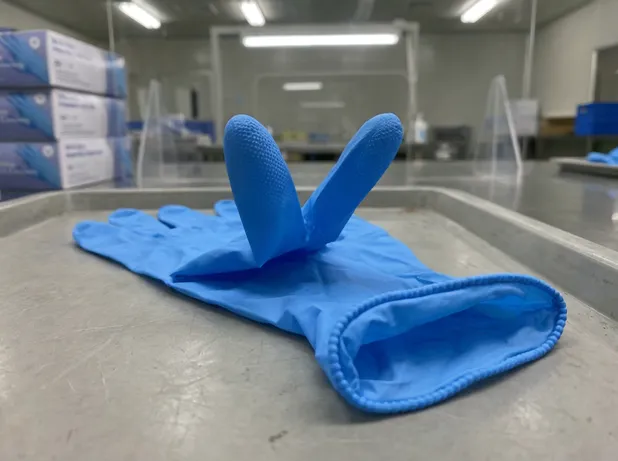 Blue nitrile glove fingertip texture and beaded cuff detail