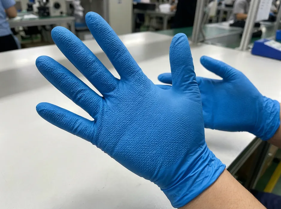 Textured blue nitrile gloves showing full-palm micro-texture surface
