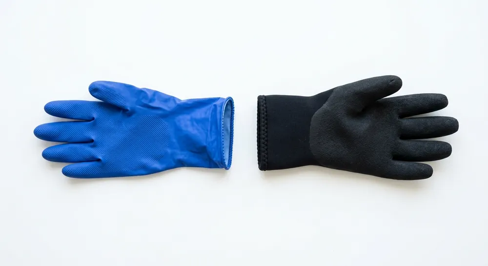 Side-by-side comparison of industrial nitrile and neoprene gloves showing material color and texture differences